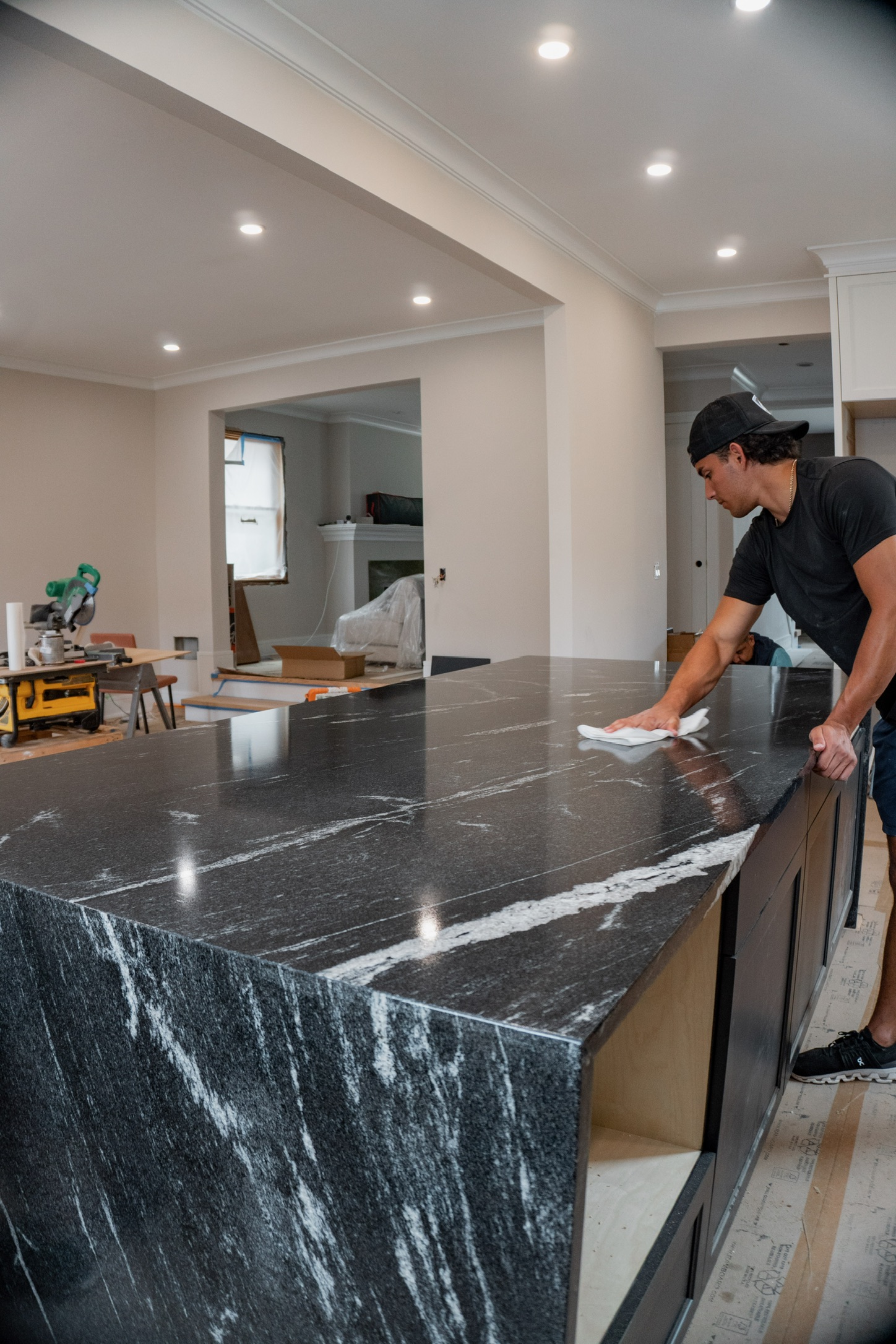 Amici Stone team member finishing a granite countertop on site