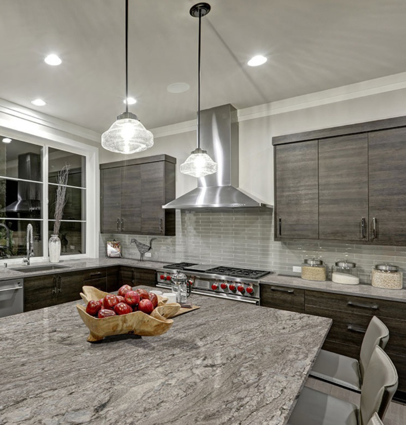 Finished kitchen with granite island installed by Amici Stone