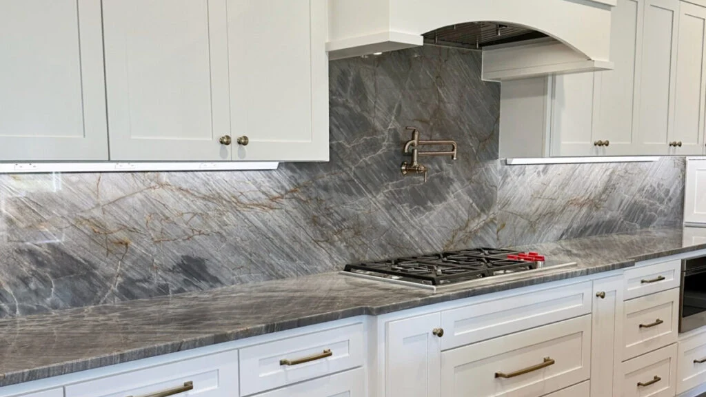 Stone slab backsplash and countertop by Amici Stone