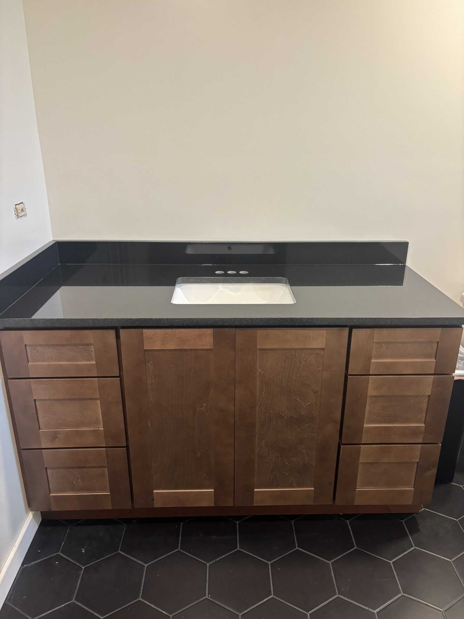Black granite bathroom vanity installed by Amici Stone